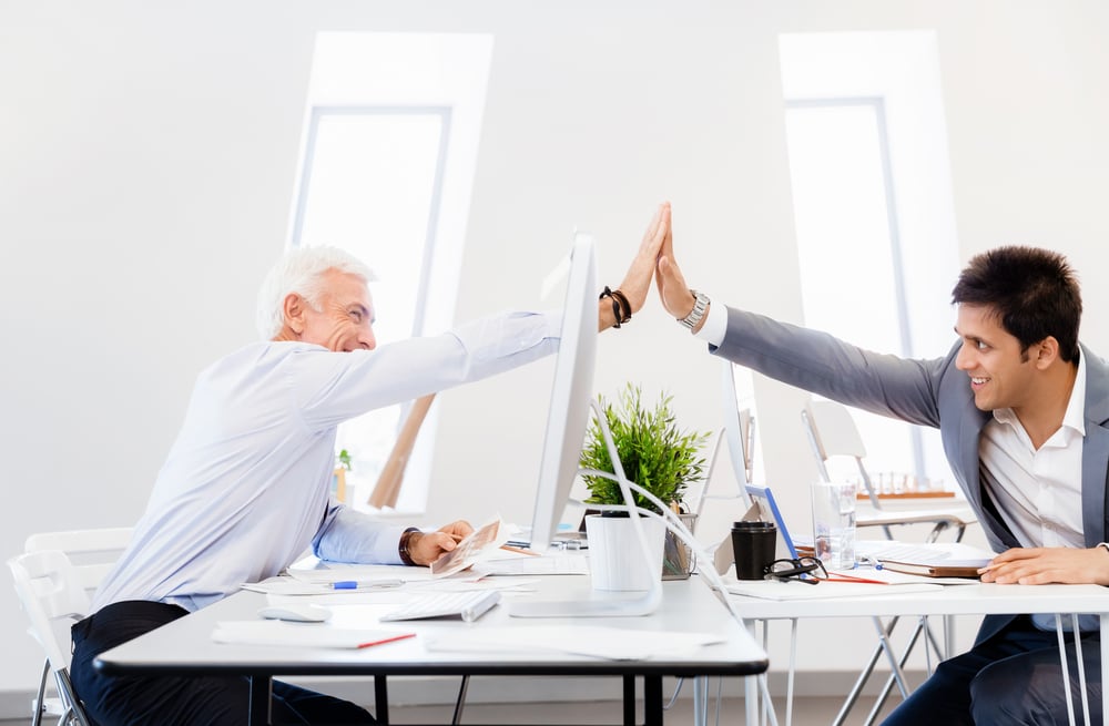 Businessmen in office cheering at their success Businessmen in office cheering at their success
